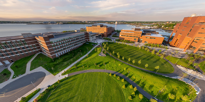 Harvard, MIT, and Boston’s city skyline with students in foreground